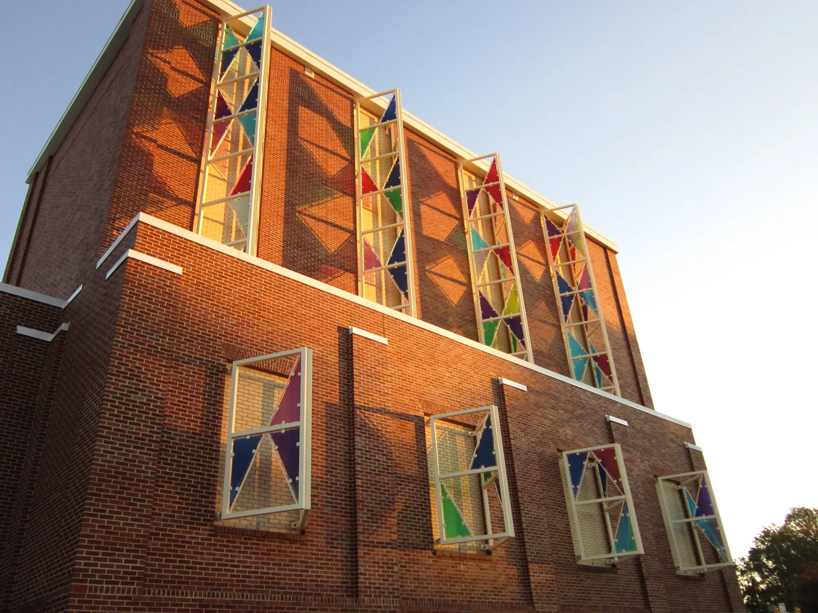 Colored glass panels on the brick wall of the Cary Arts Center on Dry Avenue, home to the Cary Town Band's and Concert Singers of Cary's concerts.