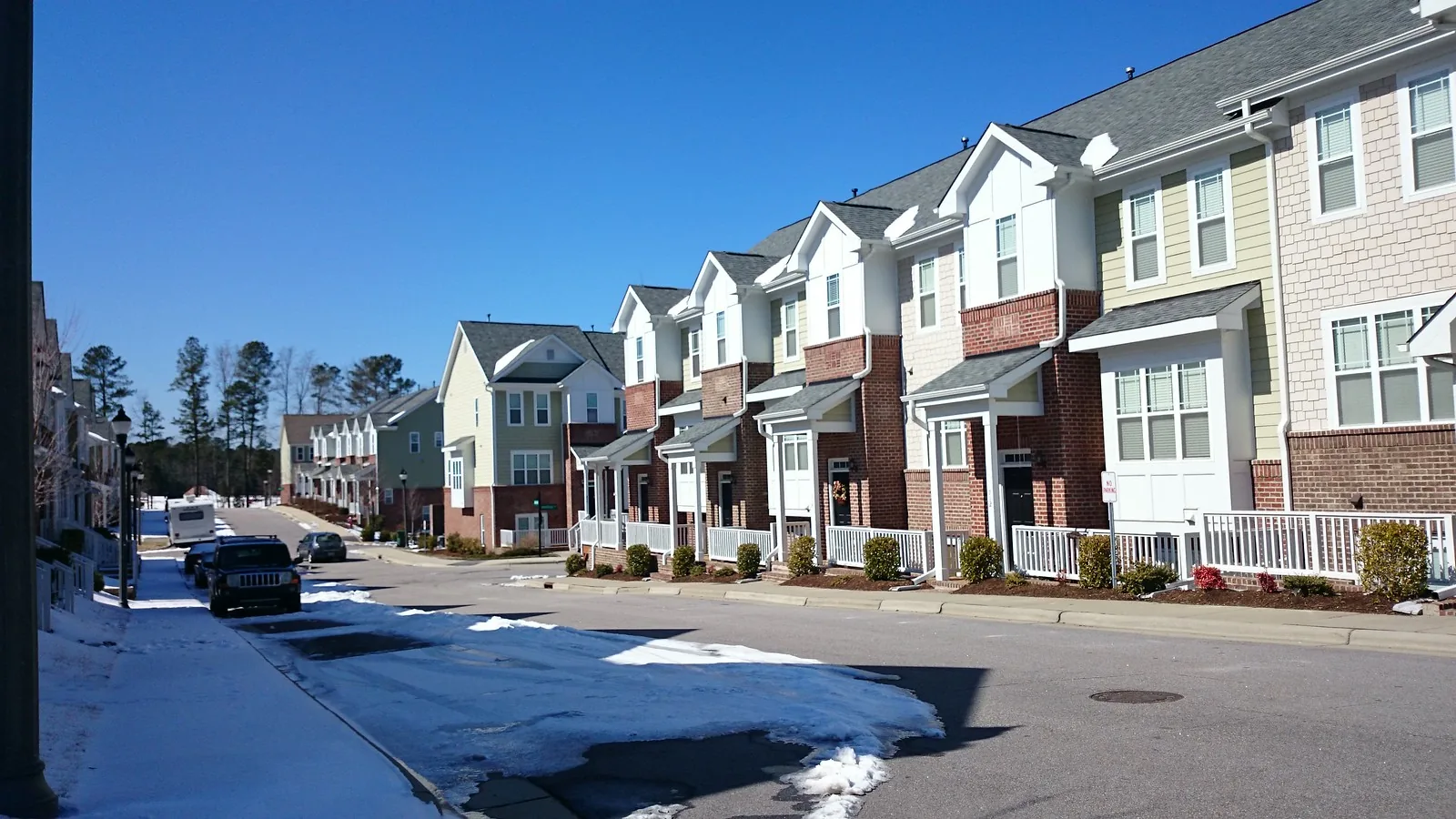 A row of newer townhomes on a residential street in Cary, the kind of single-family attached housing that leads the town's new-home permits in 2026.