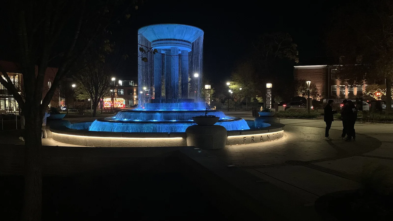 The Frantz Square fountain at Downtown Cary Park lit up at night on Thanksgiving 2023, days after the park opened; the park hosts Cary's tree lighting.
