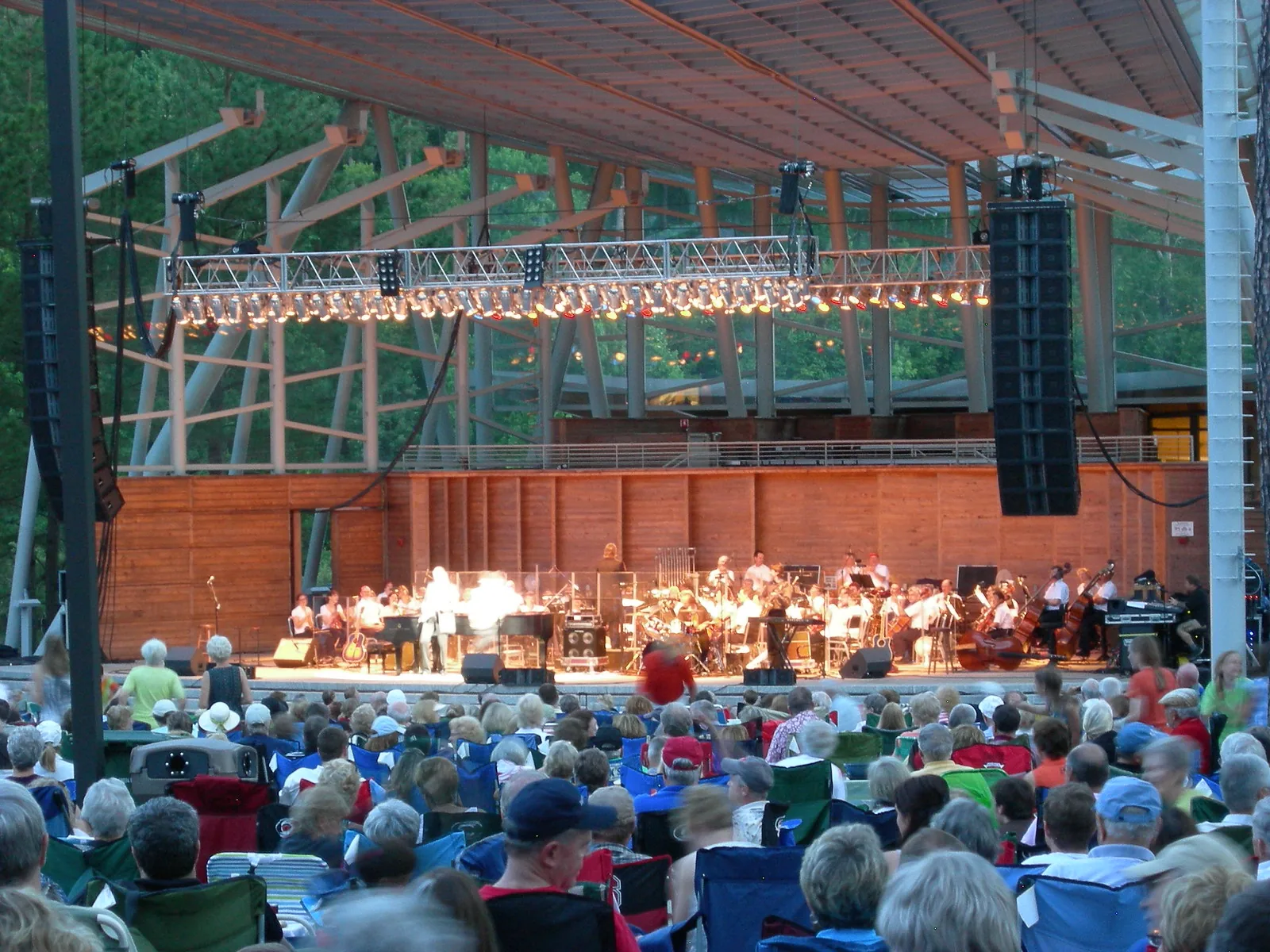 An orchestra performs for a lawn full of concertgoers at Koka Booth Amphitheatre in Cary, home of the town's Independence Day celebration.