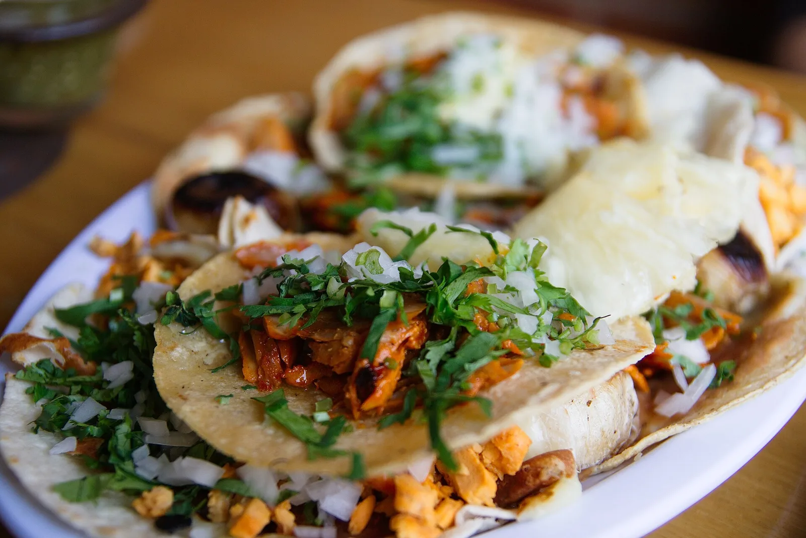 A plate of tacos al pastor with onion and cilantro. The photo was not taken in Cary.