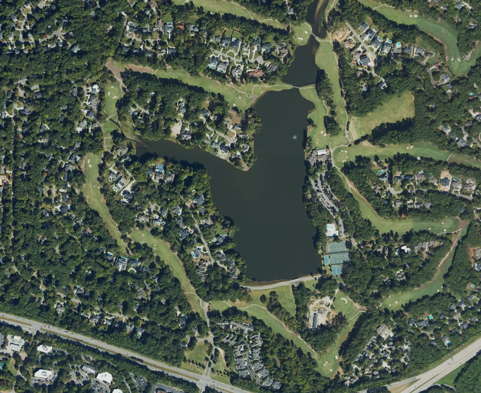 Aerial view of homes around the lake and golf course at MacGregor Downs in Cary