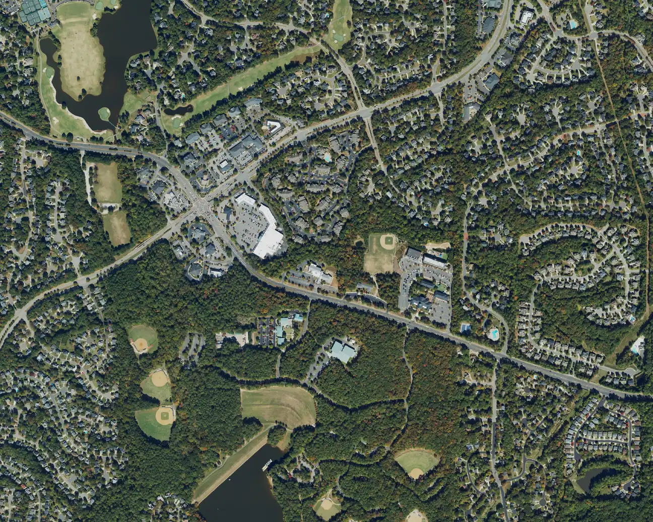 Aerial view of neighborhoods in west Cary around Fred G. Bond Metro Park, whose ballfields and lake are at the bottom
