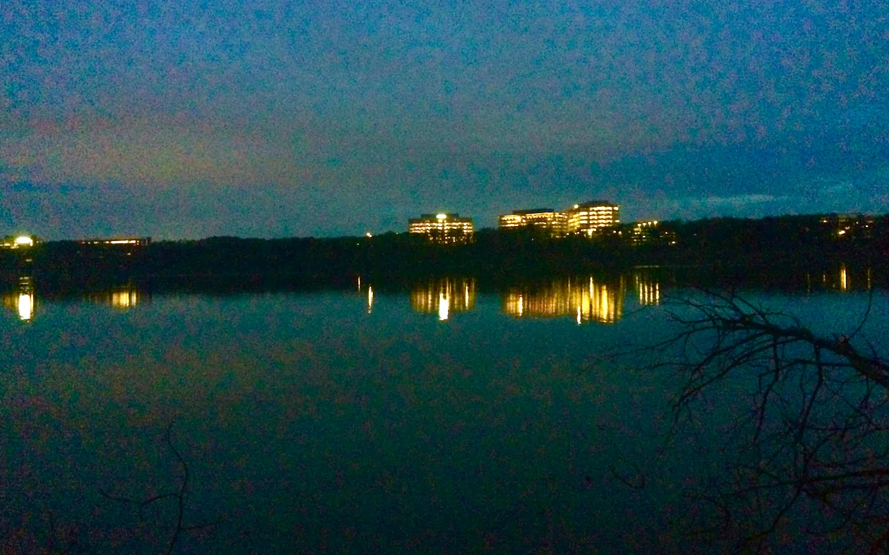 Office towers on Cary's northern edge light up the evening sky over Lake Crabtree.