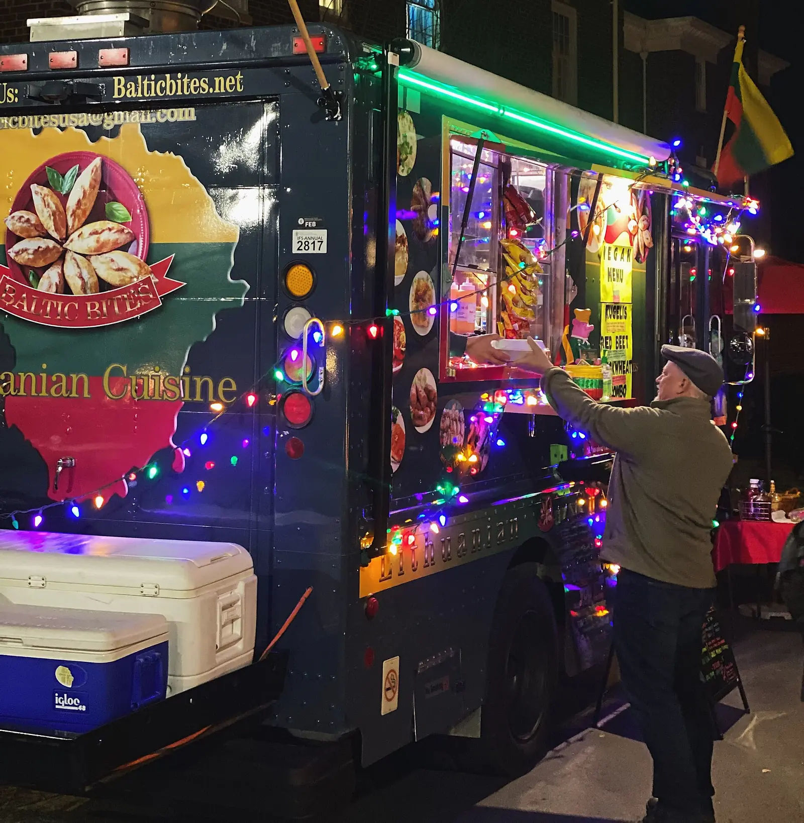 A customer picks up an order at the window of a food truck in Cary. Wake County inspects mobile food units as well as restaurants.
