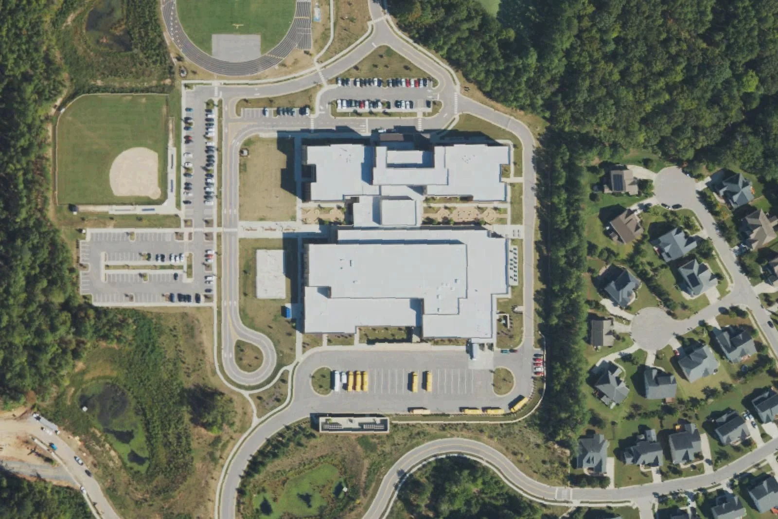 Alston Ridge Middle School's three-story building, bus lot and ball field off Fussell Avenue, seen from the air
