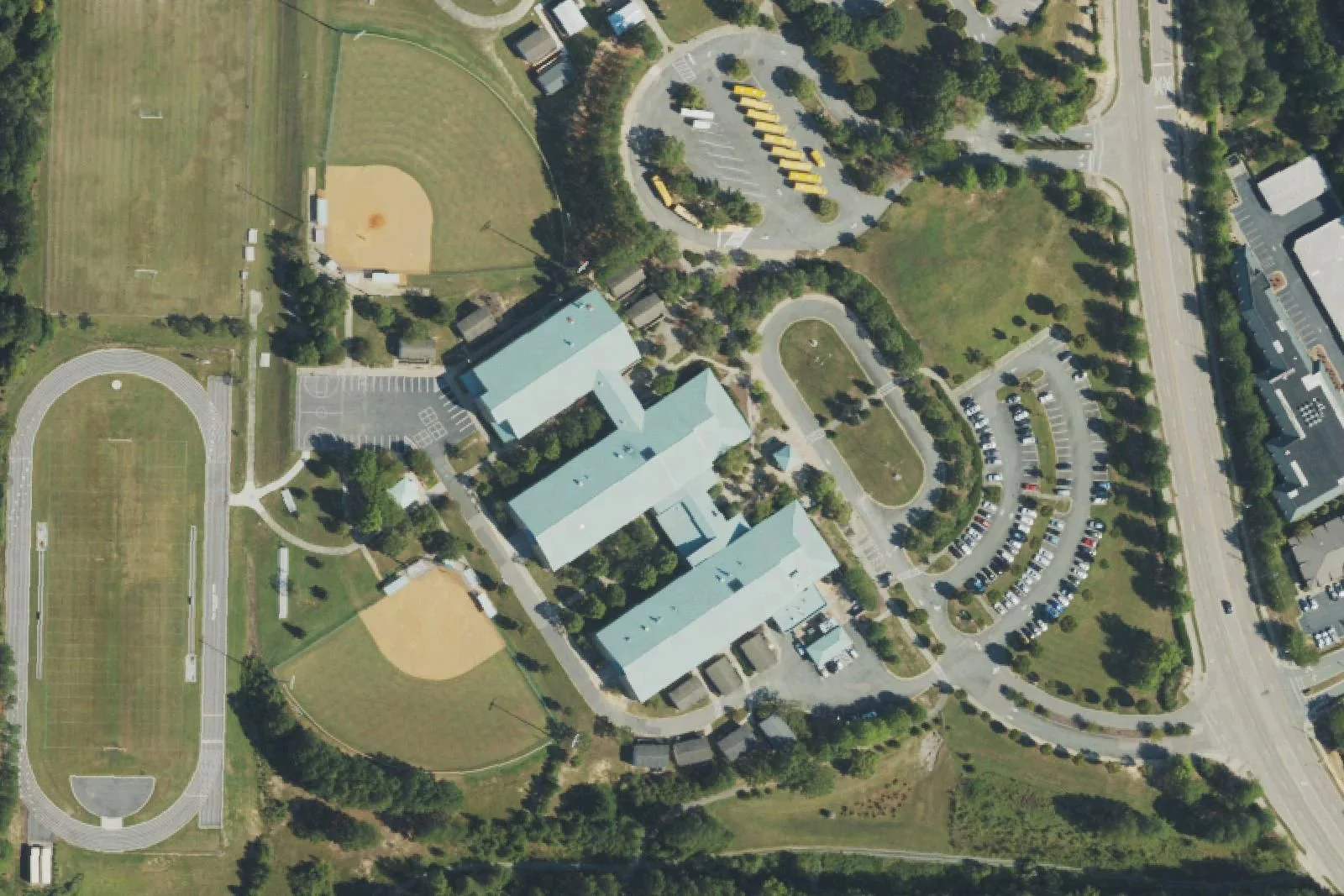 Davis Drive Middle School's wings, track, softball field and bus lot on Davis Drive, seen from the air