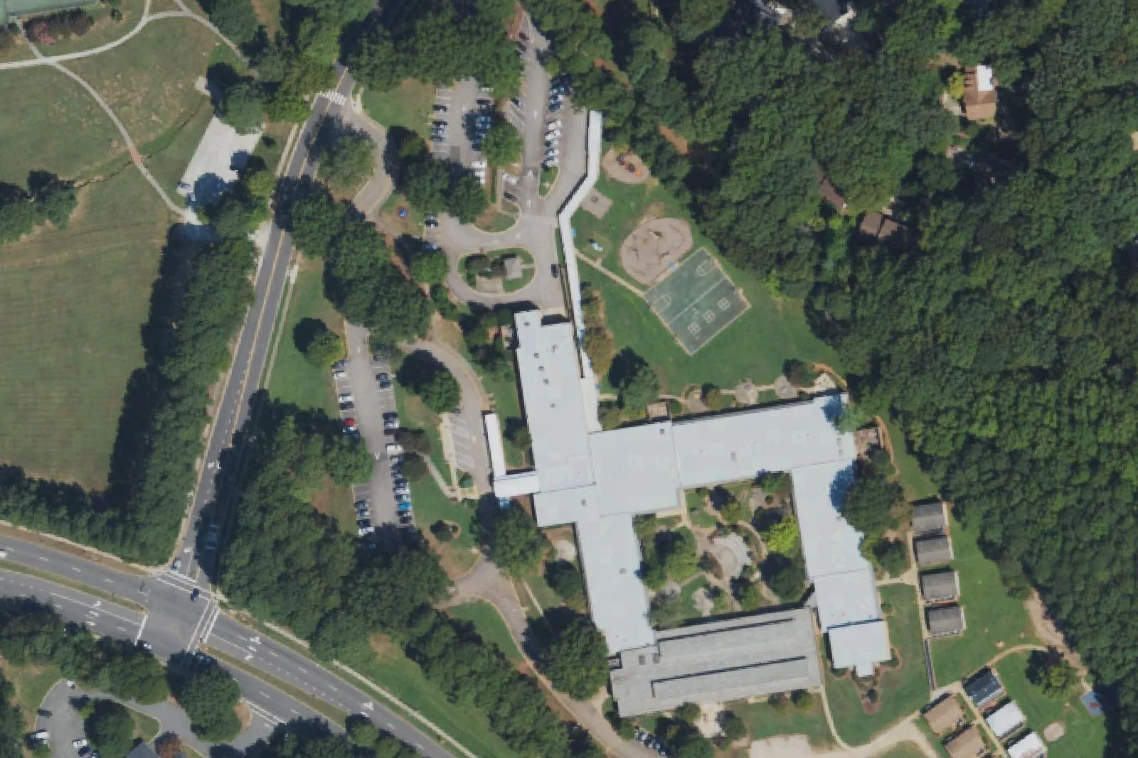 Farmington Woods Magnet Elementary School's building and courts off Hampton Valley Road, seen from the air