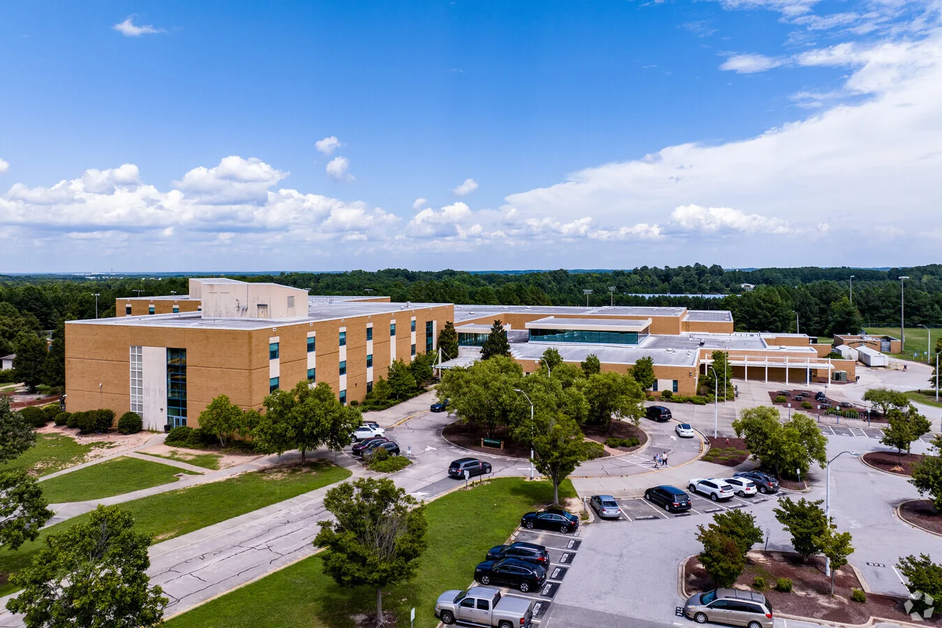 Green Hope High School's main building and parking lots on Carpenter Upchurch Road, seen from a drone