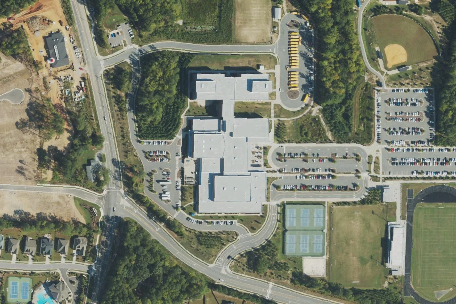 Green Level High School's main building, tennis courts, stadium and parking lots off Roberts Road, seen from the air