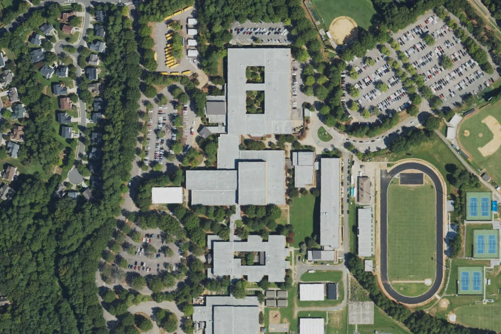 Leesville Road High School's buildings, track and stadium, tennis courts and baseball field on Pride Way in Raleigh, seen from the air