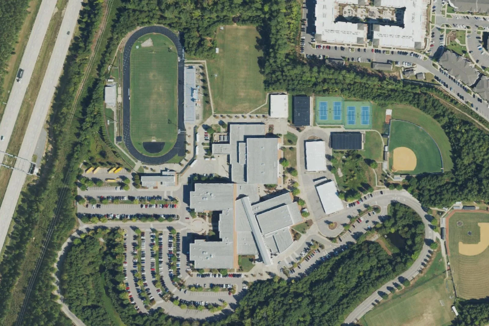 Panther Creek High School's main building, stadium, tennis courts and ball fields off McCrimmon Parkway, seen from the air