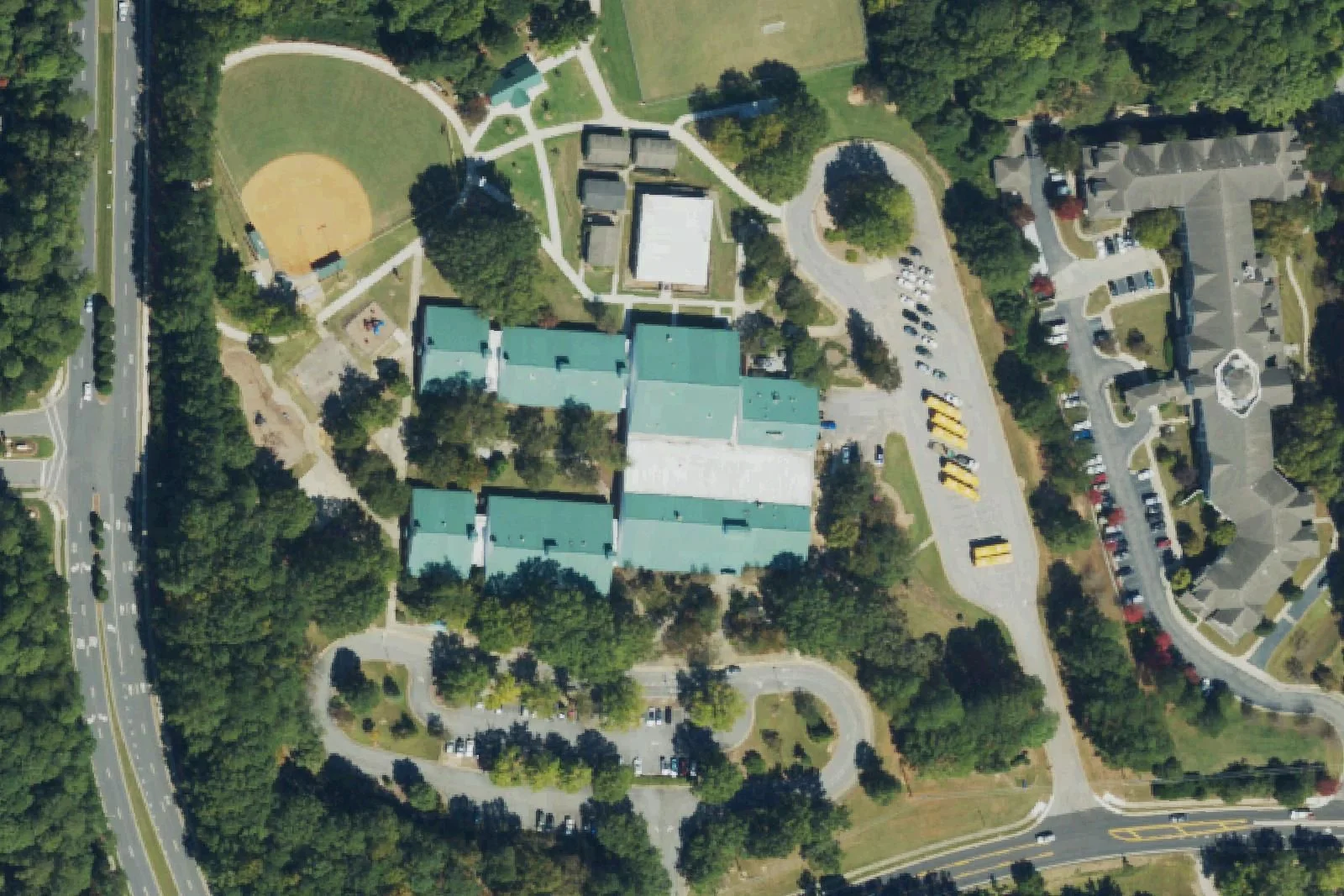 Penny Road Elementary School's green-roofed wings and ball field on Penny Road, seen from the air