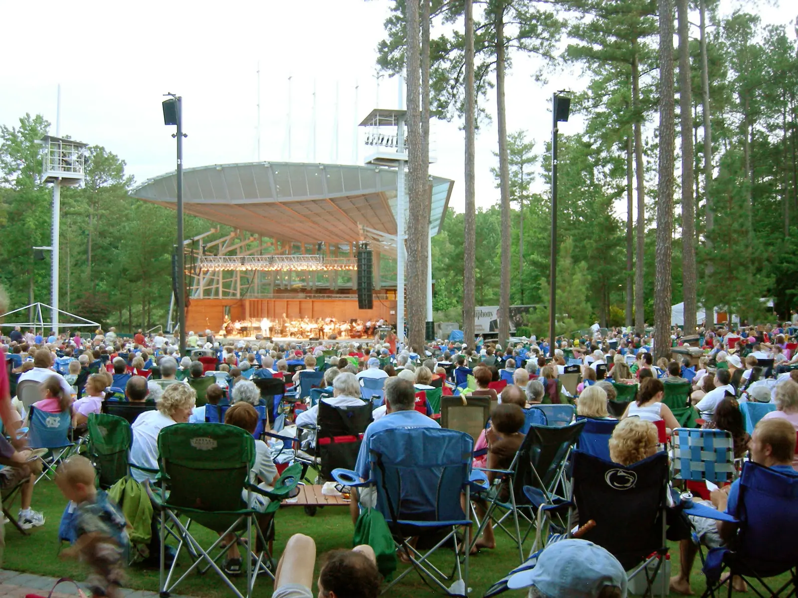A crowd in lawn chairs faces the stage at Koka Booth Amphitheatre in Cary, which hosts the Light The Night Walk on Saturday and Trampled by Turtles on Sunday.