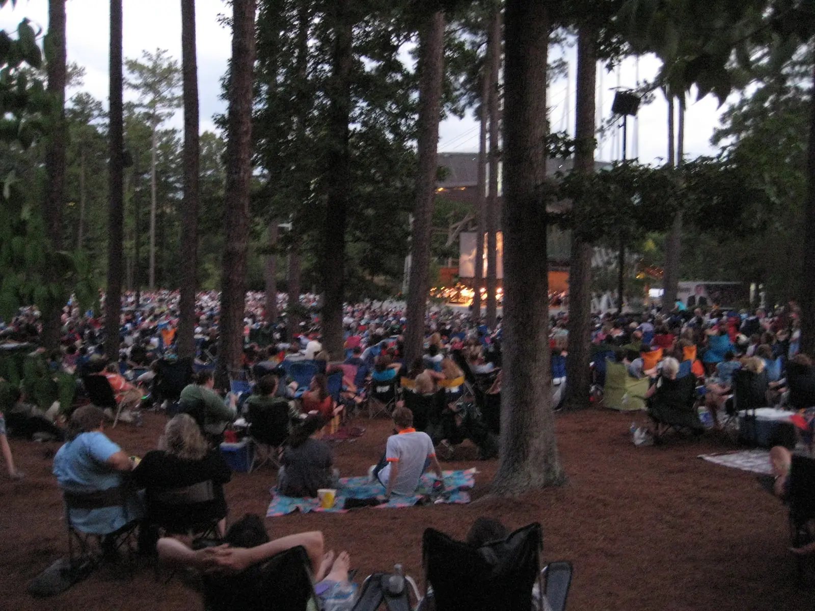 Families settle onto the pine-shaded lawn for an evening show at Koka Booth Amphitheatre in Cary, which hosts a Trunk or Treat on Oct. 23.