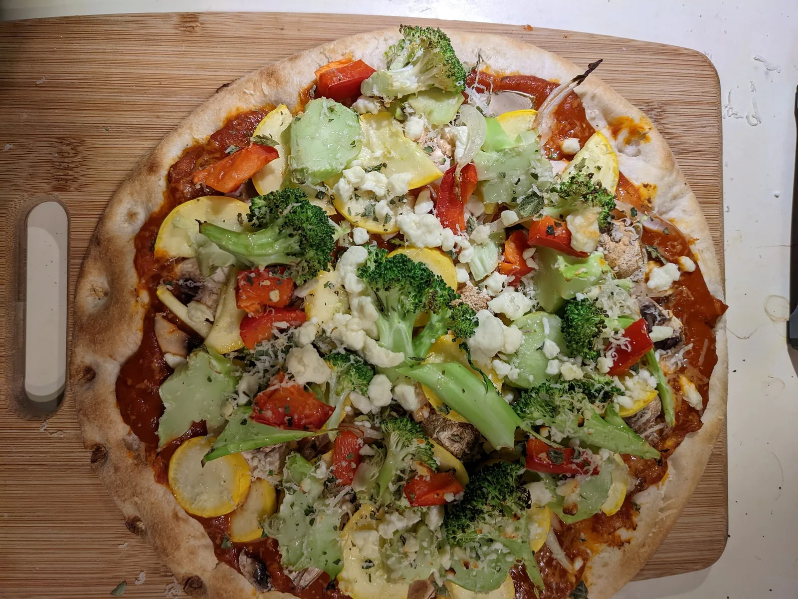 A vegetable pizza with broccoli, squash and red peppers, photographed in Cary. It is not from a restaurant on this list.